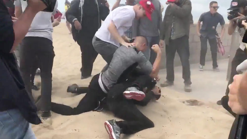 Violence erupted at a “Make America Great Again” rally in Huntington Beach, Calif., when a protester opposed to President Trump allegedly doused the organizer of the event with pepper spray and was immediately pummeled by Trump supporters. (Cindy Carcamo/Los Angeles Times)